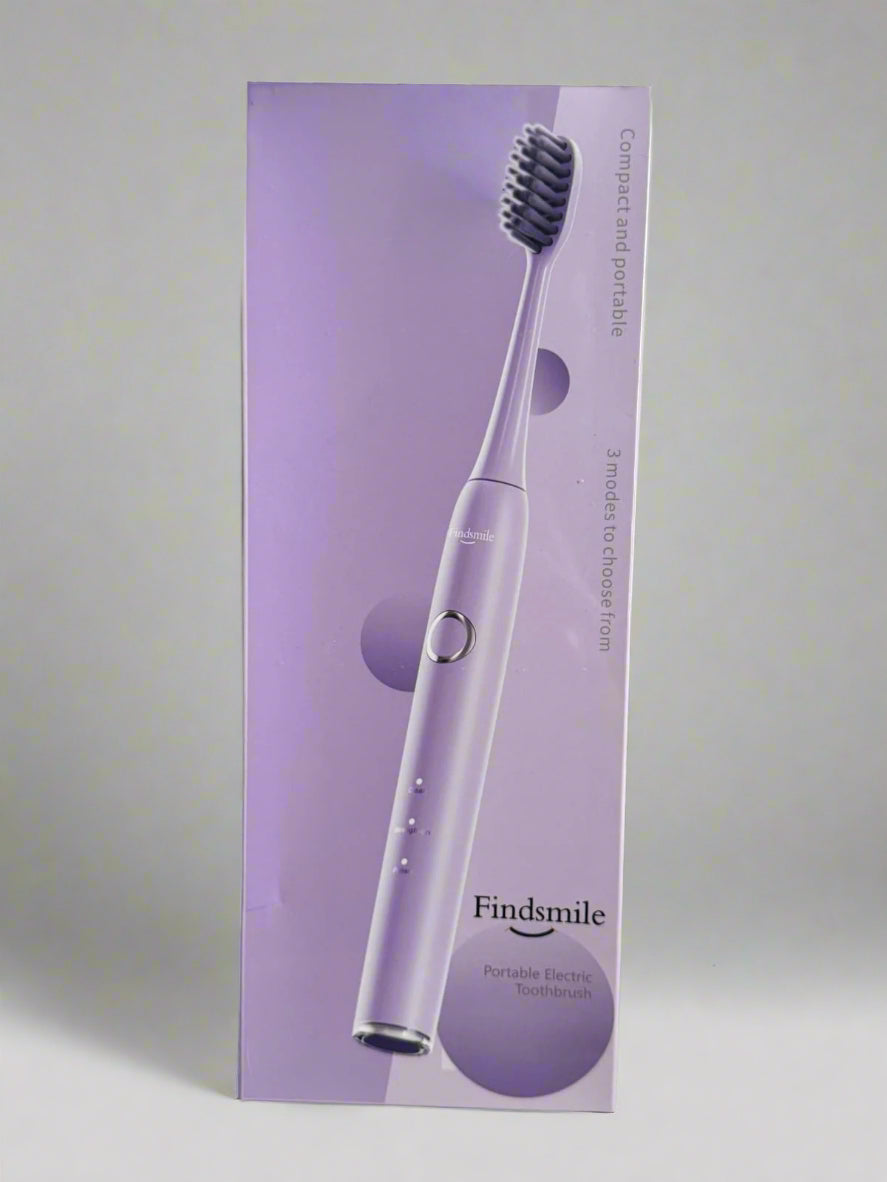 Purple Findsmile dental toothbrush packaging on a textured surface